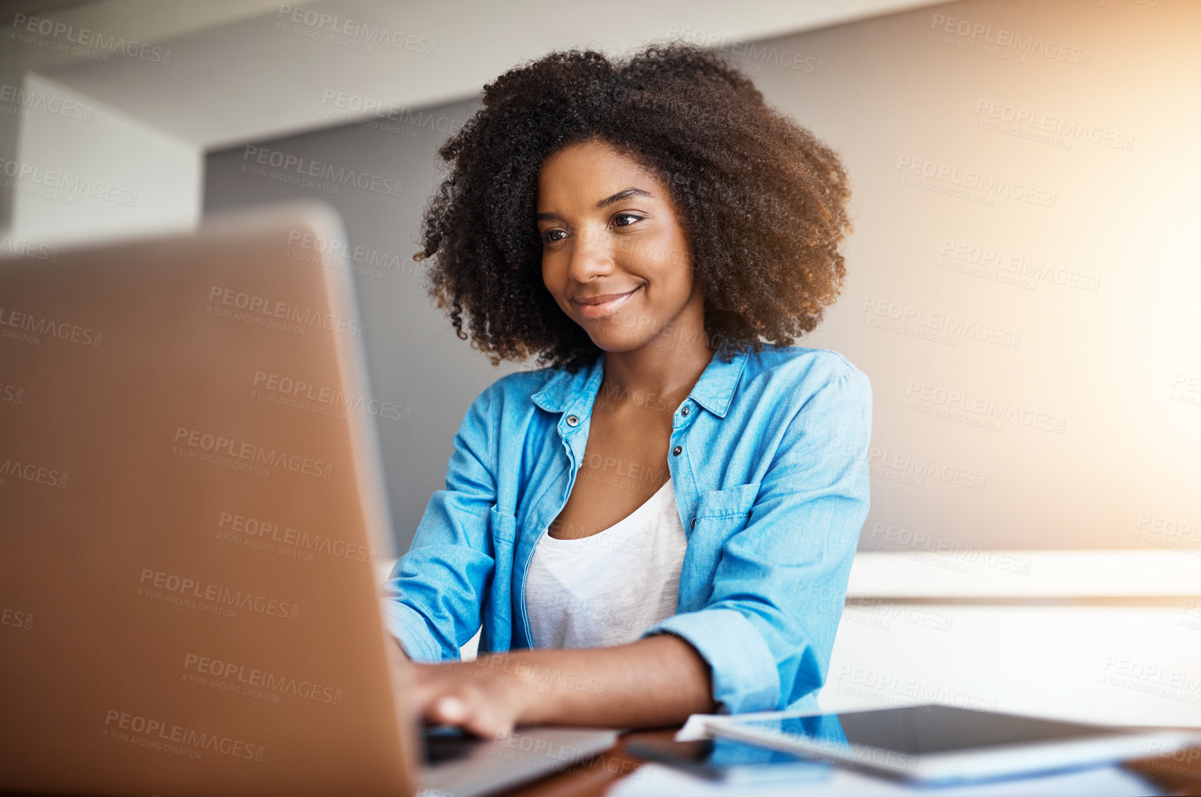 Buy stock photo Shot of an attractive young woman working on her laptop at home