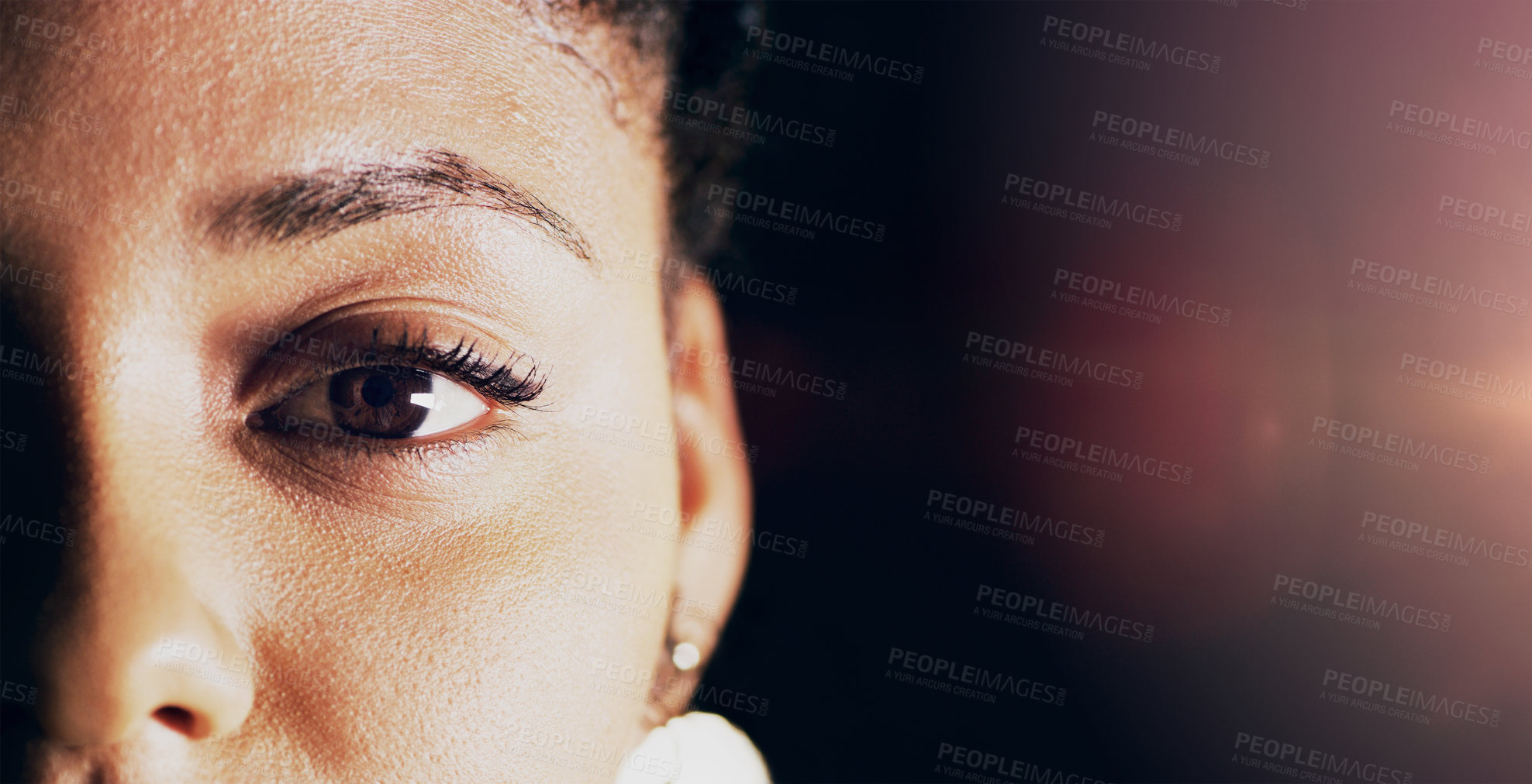 Buy stock photo Closeup shot of a beautiful young woman's eye against a dark background