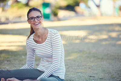 Buy stock photo Portrait of an attractive young woman relaxing in the park