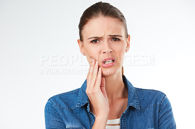 Buy stock photo Studio portrait of a young woman experience tooth ache a grey background