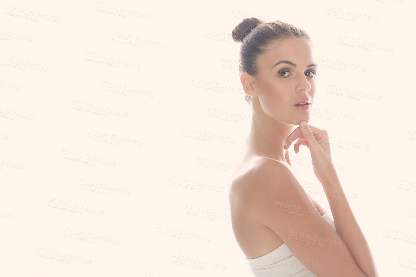 Buy stock photo Cropped shot of a beautiful young woman posing against a light background