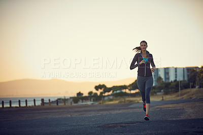 Buy stock photo Shot of a sporty young woman exercising outdoors