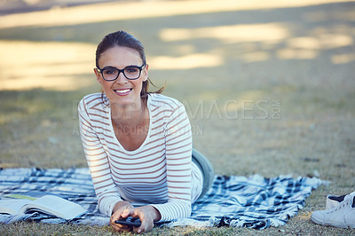 Buy stock photo Portrait of an attractive young woman relaxing in the park