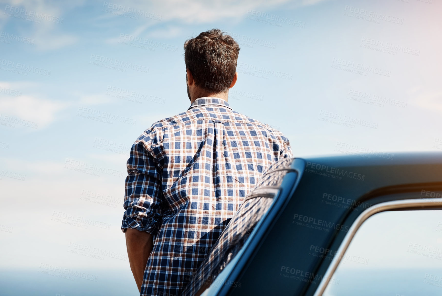 Buy stock photo Rearview shot of a young man looking at the view while on a road trip