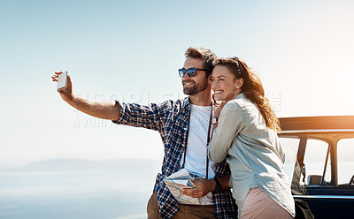 Buy stock photo Cropped shot of an affectionate couple taking a selfie while enjoying a road trip