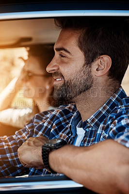 Buy stock photo Shot of a handsome young man out on a road trip with his partner,