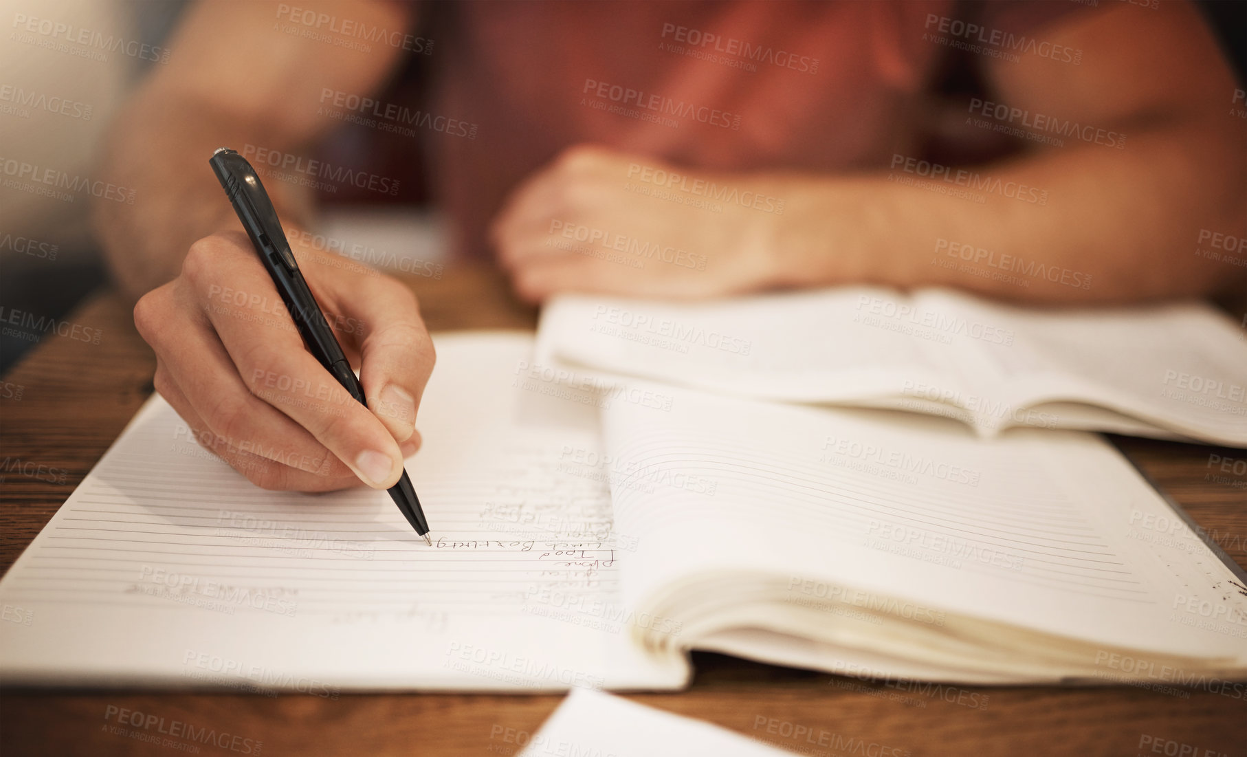 Buy stock photo Student, hand and writing in notebook at desk for studying, learning or assignment deadline in library. University, education and person with pen for knowledge, scholarship or working on thesis