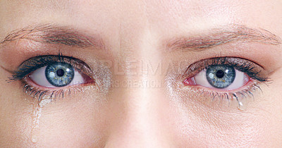 Buy stock photo Closeup shot of a young woman's tearful eyes in studio