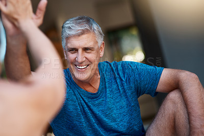 Buy stock photo Shot of a mature and motivated couple congratulating each other at the end of an intense workout session