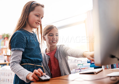 Buy stock photo Cropped shot of two elementary school children browsing on a computer inside of the class during the day