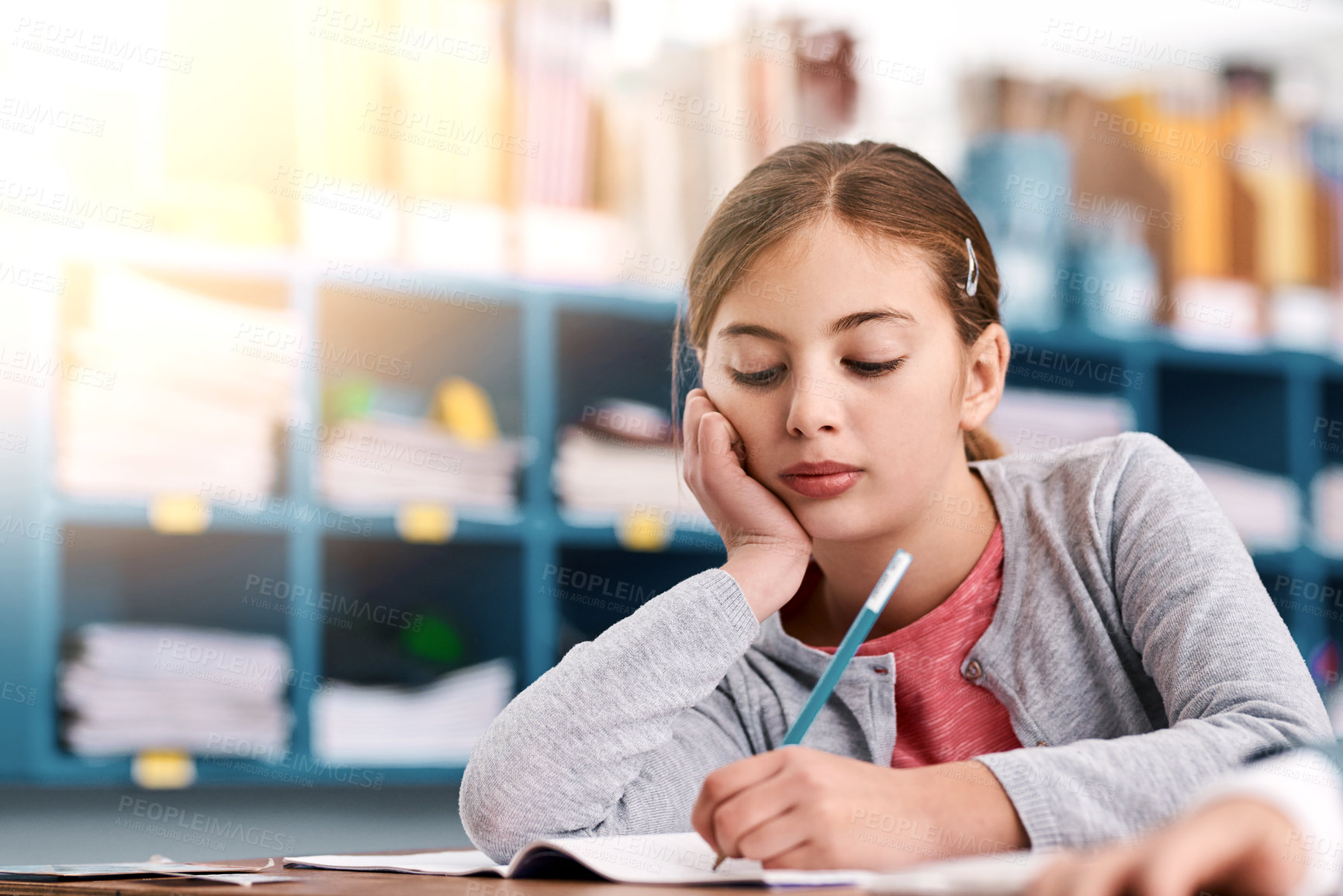 Buy stock photo Cropped shot of a elementary school kid trying to do work in the class at school during the day