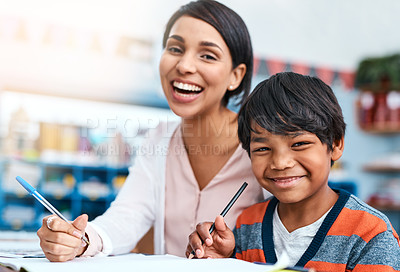 Buy stock photo Portrait of a cheerful young female teacher helping a student inside of the class at school