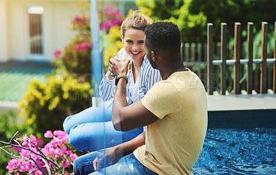 Buy stock photo Couple, poolside and drinking or cheers in outdoor, bonding and together for love or talking. People, toast and speaking on holiday or vacation, alcohol and trees or celebration for peace and calm