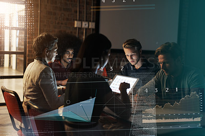 Buy stock photo Shot of a group of young businesspeople sitting around a table and using their digital devices at work