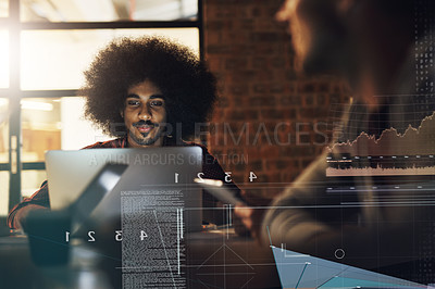 Buy stock photo Shot of a handsome young businessman working on his computer during a meeting with colleagues at work