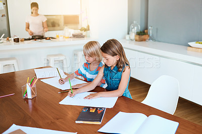 Buy stock photo Shot of two adorable young children doing their homework together at home