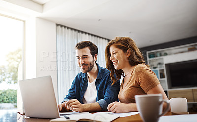 Buy stock photo Shot of a young couple watching online videos together while doing their monthly budget at home