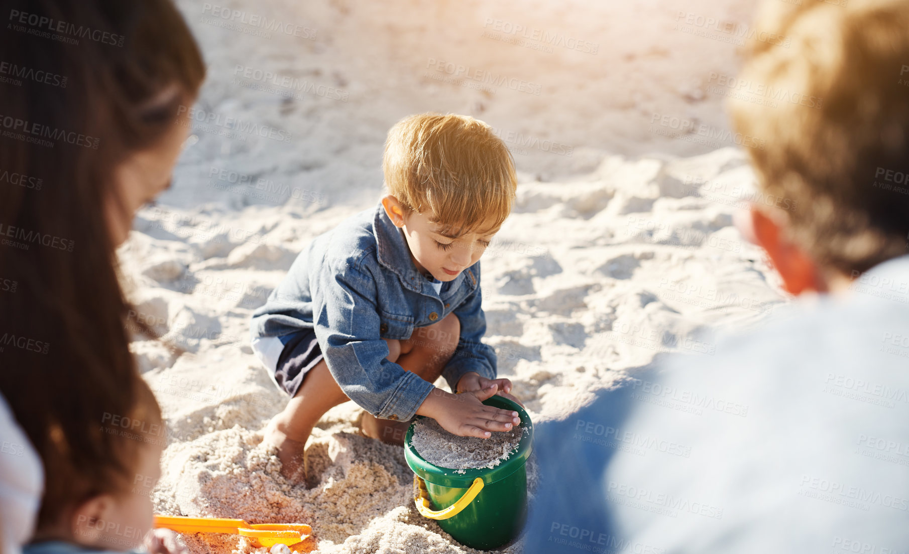 Buy stock photo Summer, beach and boy with parents, sand and sunshine with vacation, toys and bonding together. Family, mother and father with son, seaside and adventure with holiday, getaway trip and weekend break