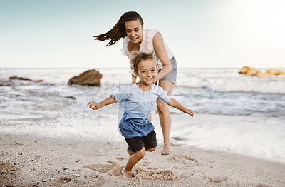 Buy stock photo Shot of a mother bonding with her little son at the beach