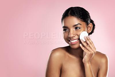 Buy stock photo Skincare, mockup and happy woman with cotton pad on face, smile and makeup removal with skin product in studio. Dermatology, facial cleansing cosmetics and African model isolated on pink background.