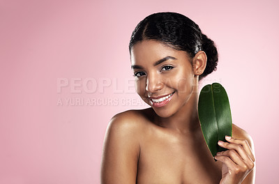 Buy stock photo Portrait, happy woman and leaf of skincare in studio, pink background and mockup of eco friendly cosmetics. Face, smile and african model for natural beauty, green plants and aesthetic sustainability