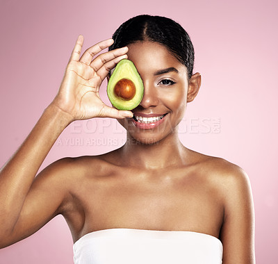 Buy stock photo Avocado, portrait and beauty of woman in studio, pink background and aesthetic glow. Happy african model, natural skincare and fruit for sustainable cosmetics, vegan dermatology and facial benefits