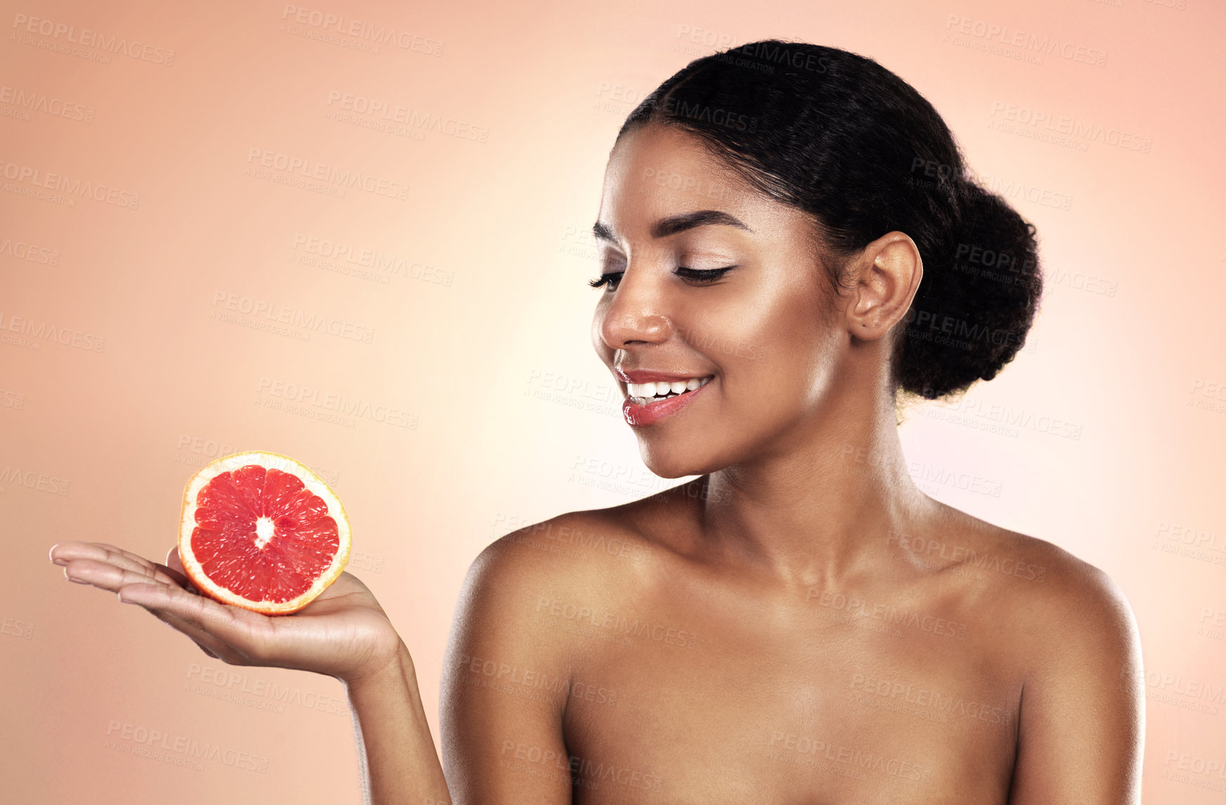 Buy stock photo Grapefruit, natural beauty and happy woman in studio, background and sustainable mockup. African model, healthy skincare and citrus fruits for cosmetics, organic dermatology and vitamin c benefits