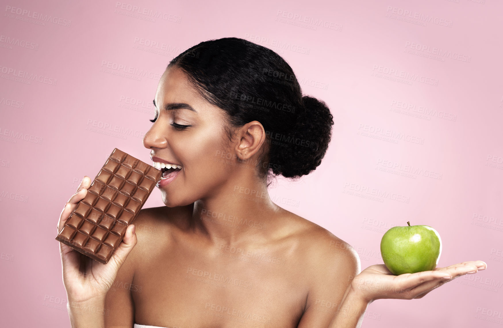 Buy stock photo Black woman, health choice and fruit or chocolate option isolated on studio background. Young female person or model and food decision for balanced diet, weight loss journey and organic benefits