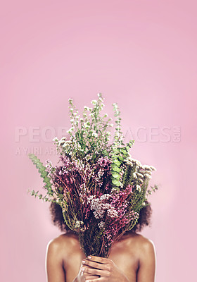 Buy stock photo Studio shot of a woman covering her face with a bunch of flowers