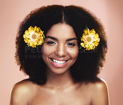 Buy stock photo Portrait of happy woman, afro and yellow flowers in studio background for beauty, floral aesthetic and shine. Face of african model, skincare and daisy plants in hair for happiness, perfume or makeup