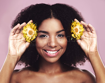 Buy stock photo Happy woman, hair and daisy flowers in studio, pink background and floral aesthetic of natural beauty. Portrait, face and african model with yellow plants, afro and smile for vegan cosmetic skincare