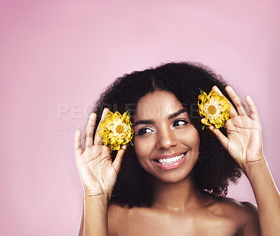 Buy stock photo Happy woman, hair care and thinking with flowers in studio, pink background and sustainable mockup. Face, african model and daisy plants in afro to think of natural skincare, beauty ideas and makeup