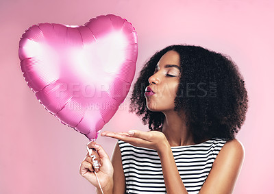 Buy stock photo Studio, celebration and girl with ballon in heart shape, blowing kiss and flirting with eyes closed. Female model, anniversary or valentines gift by pink background, surprise or present for woman