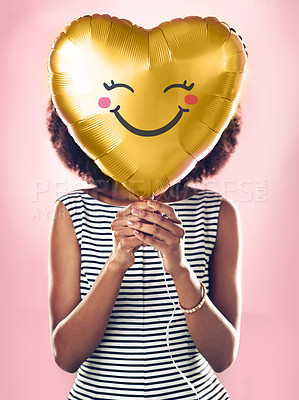 Buy stock photo Love, smile and a woman with a heart balloon isolated on a pink background in a studio. Happy, cute and a girl holding a present or gift for valentines day or a birthday for care and happiness