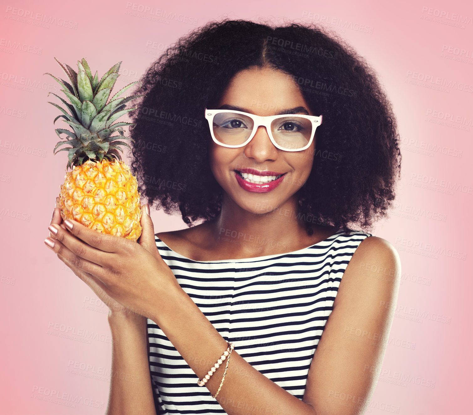 Buy stock photo Portrait, black woman and pineapple with fashion, studio and smile on pink background. Face, fruit and summer clothing aesthetic for female model, natural and ethical or sustainable material style