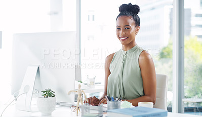 Buy stock photo Portrait of an attractive young businesswoman working at her desk in a modern office