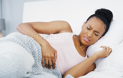 Buy stock photo Stomach, pain and problem with woman in bed for menstruation, medical and pms. Endometriosis, healthcare and period with person suffering in bedroom at home for uncomfortable, bloated and sad
