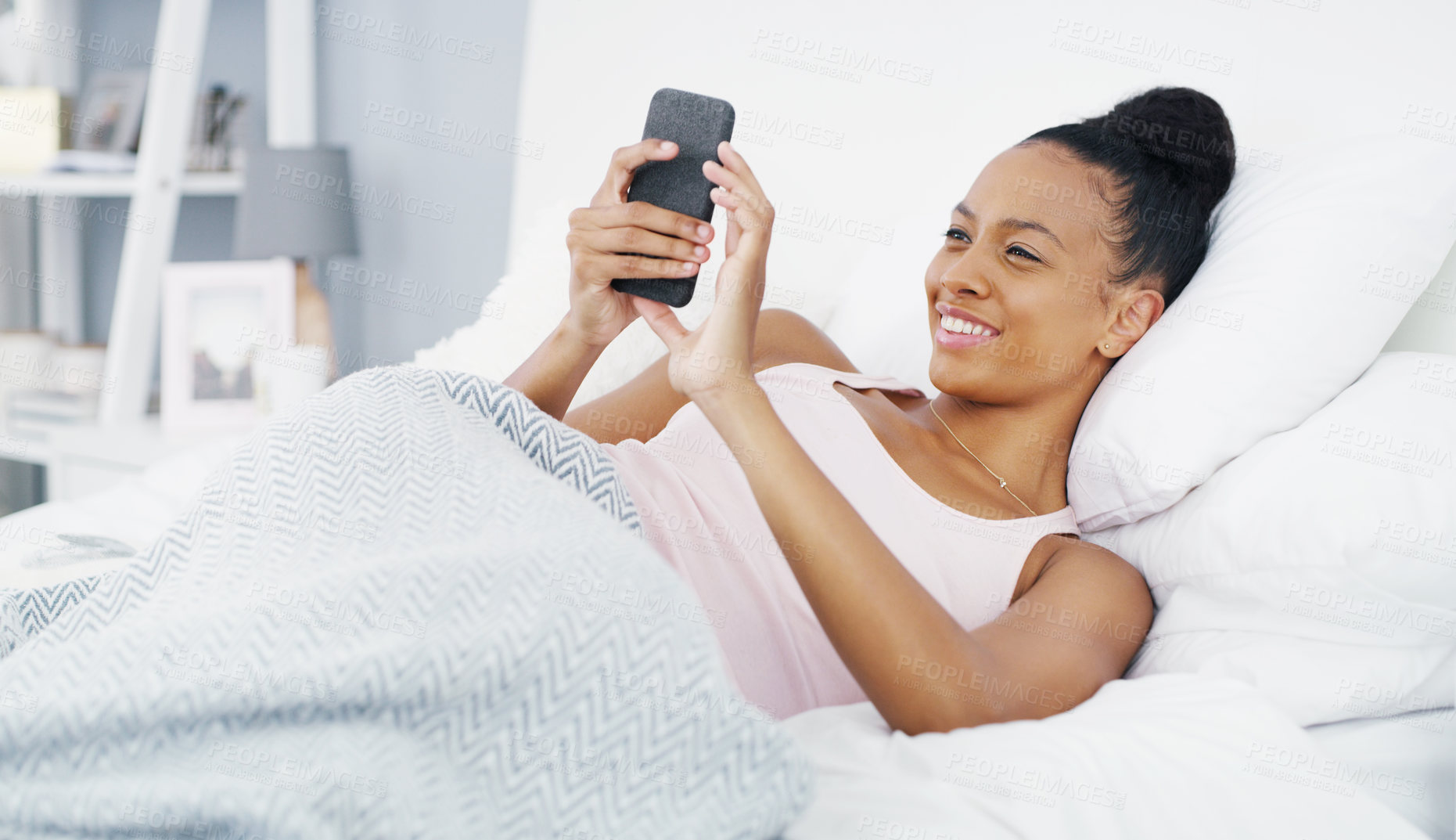 Buy stock photo Phone, happy and woman in bed with smile for social media post, internet humor and funny message. Communication, home and female African person in bedroom on smartphone mobile app, website and online