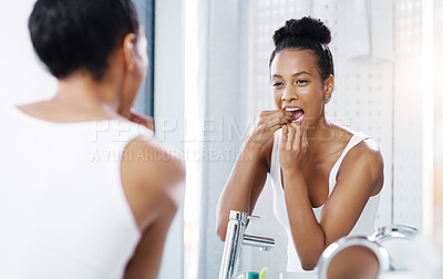 Buy stock photo Woman flossing teeth in bathroom, mirror and oral hygiene, morning routine with product for dental health. Female person at home with grooming and self care, clean mouth with floss and wellness