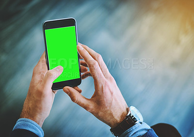 Buy stock photo Shot of an unrecognizable businessman using his cellphone at work