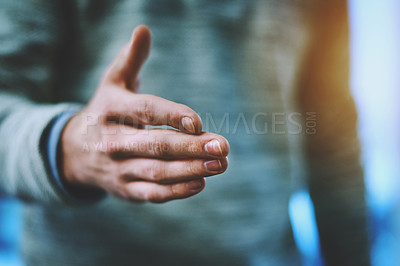 Buy stock photo Shot of an unrecognizable businessman opening his hand up for a handshake at work