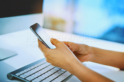 Buy stock photo Shot of an unrecognizable businesswoman using her cellphone at her office desk at work