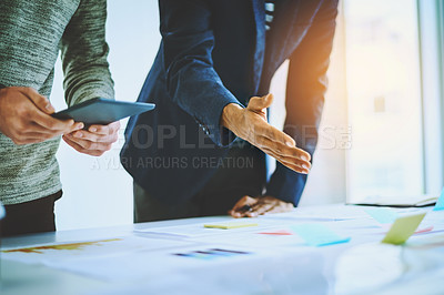 Buy stock photo Shot of two unrecognizable businessmen discussing ideas during a boardroom meeting at work