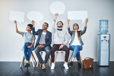 Buy stock photo Full length shot of a diverse group of businesspeople holding up speech bubbles while they wait in line