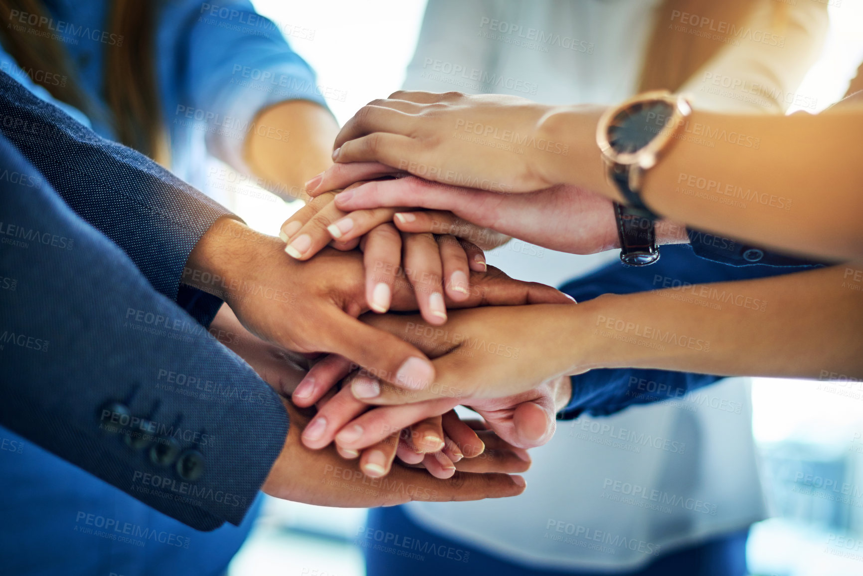 Buy stock photo Cropped shot of a group of unrecognizable businesspeople joining their hands together in unity