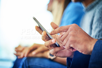 Buy stock photo Cropped shot of unrecognizable   businessman using a smartphone during a conference in a modern office
