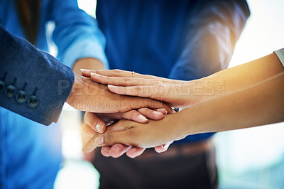 Buy stock photo Cropped shot of a group of unrecognizable businesspeople joining their hands together in unity