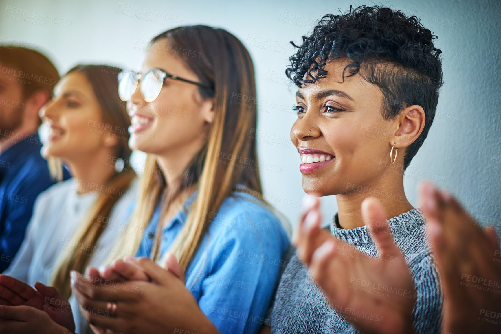 Buy stock photo Cropped shot of a group of attractive young businesswomen applauding during a conference in a modern office