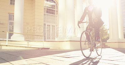 Buy stock photo Shot of an unrecognizable businessman commuting to work with his bicycle