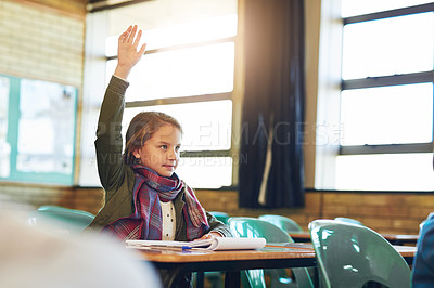Buy stock photo Shot of an adorable elementary schoolgirl raising her hand in class